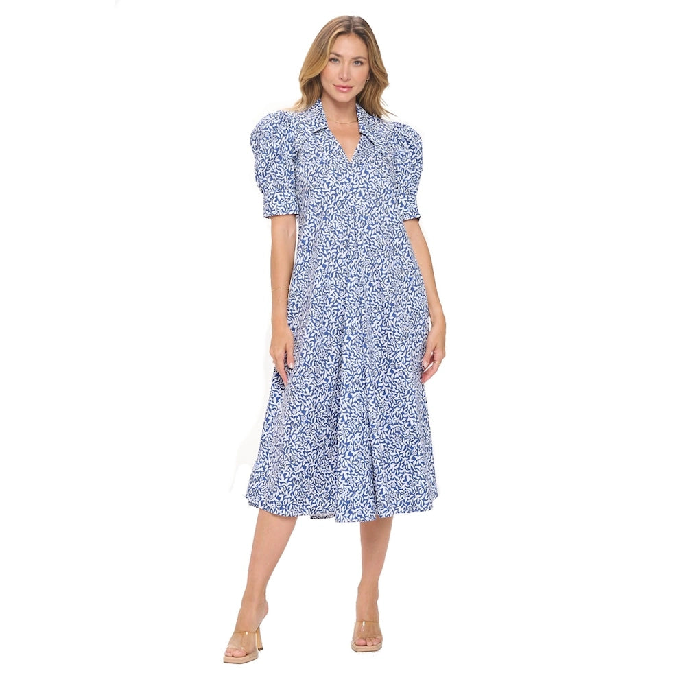 Woman in a blue and white floral bubble sleeve pleated midi dress with a V-neck and collar.