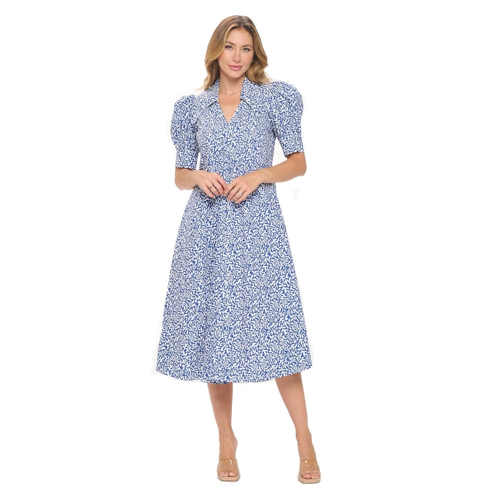 Woman in a blue and white floral midi dress with bubble sleeves, a collared V-neck, and pleated skirt on a white background.