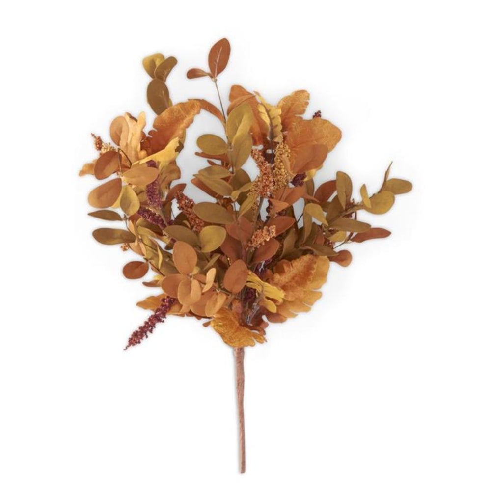An artificial bouquet of rust-brown and golden autumn leaves and small textured sprigs on a white background.