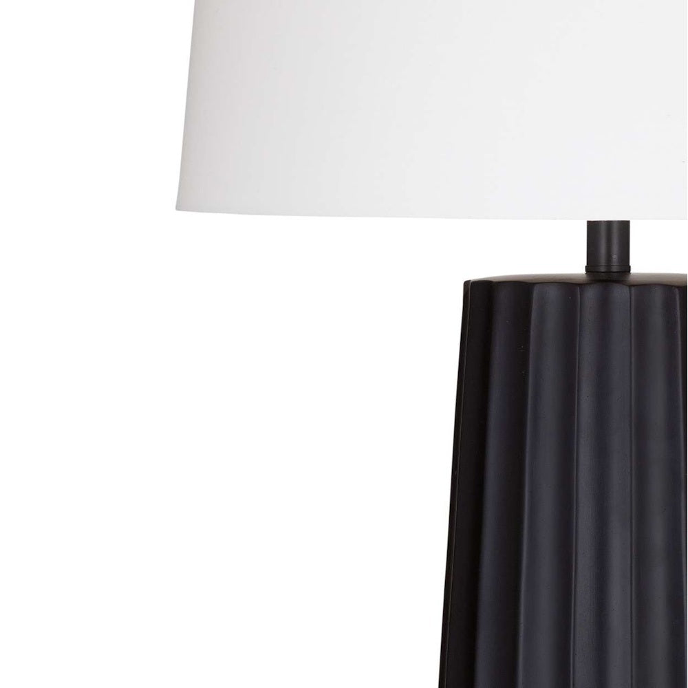 Modern black ribbed ceramic table lamp with white fabric drum shade, minimalist home decor lighting.