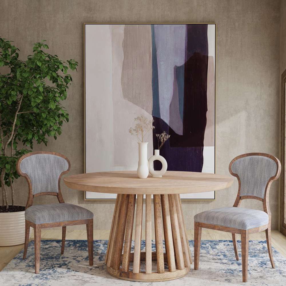 Modern dining set with a round wooden table, two grey chairs, and a large abstract painting on the wall.