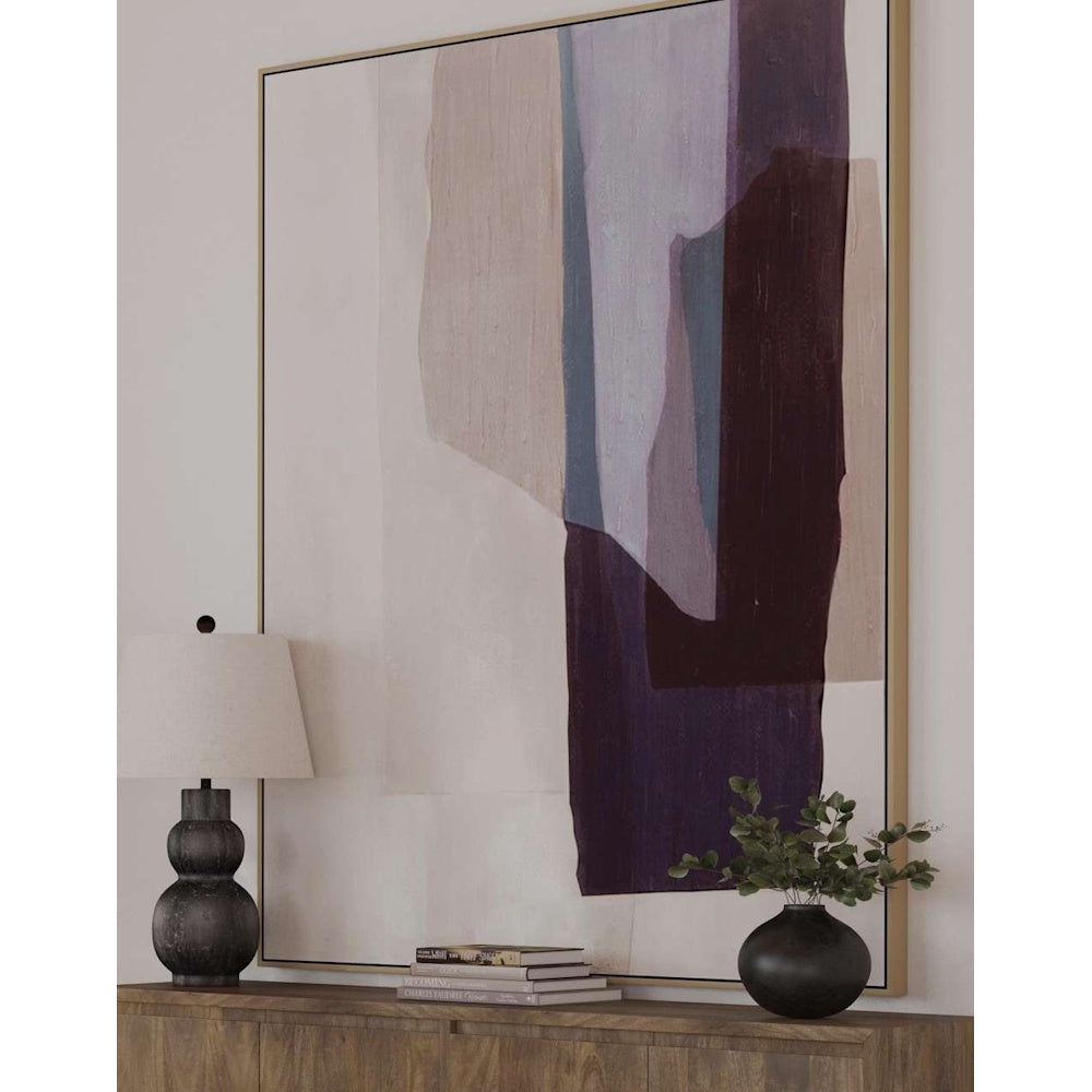 Large abstract painting with purple and tan shapes above a wood sideboard with a lamp and vase.