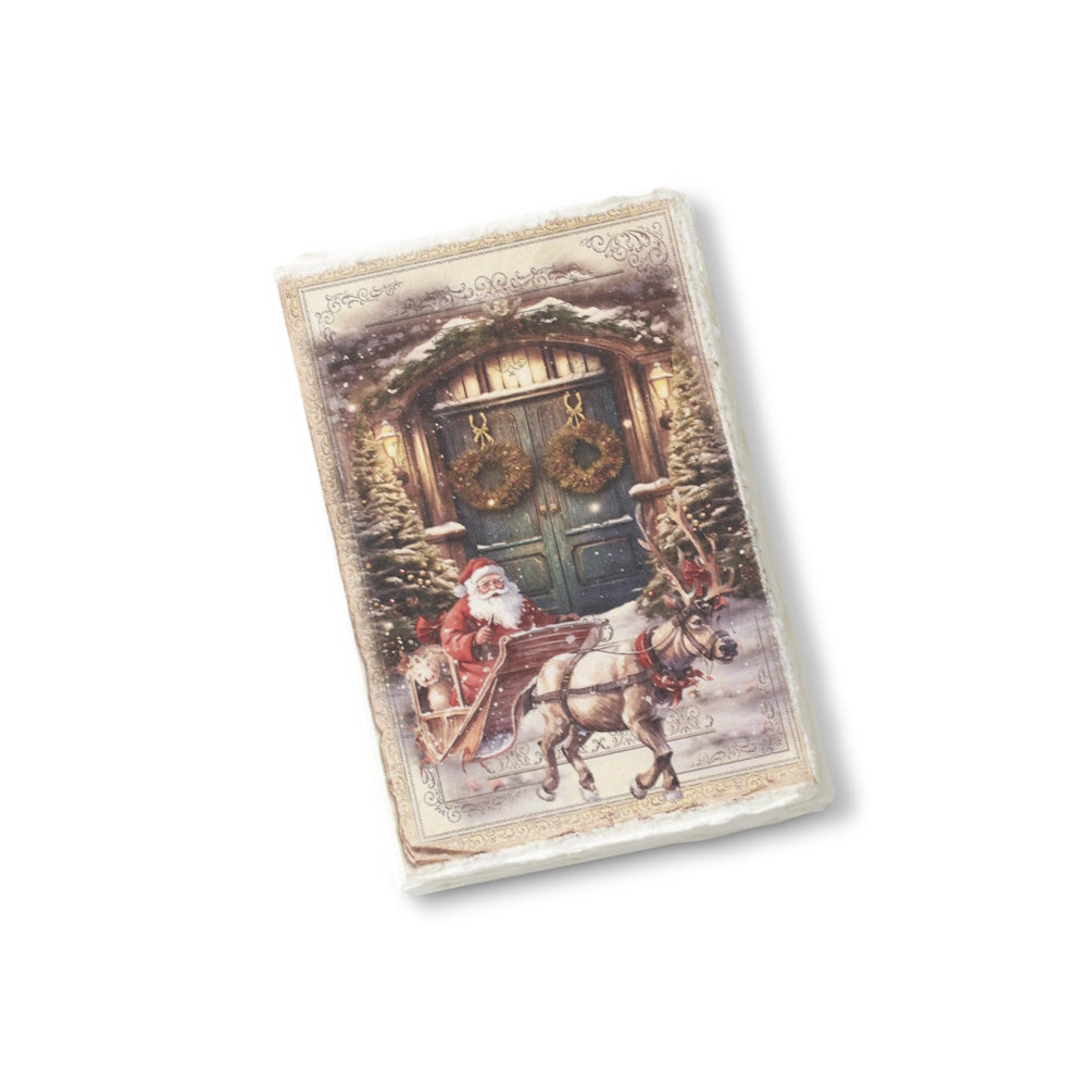 A soft-cover Christmas journal featuring a vintage illustration of Santa in a sleigh pulled by a reindeer, finished with a deckle edge.