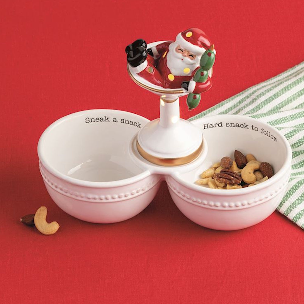 Two-bowl white ceramic snack dish topped with Santa in a martini glass holding olive stirrers.