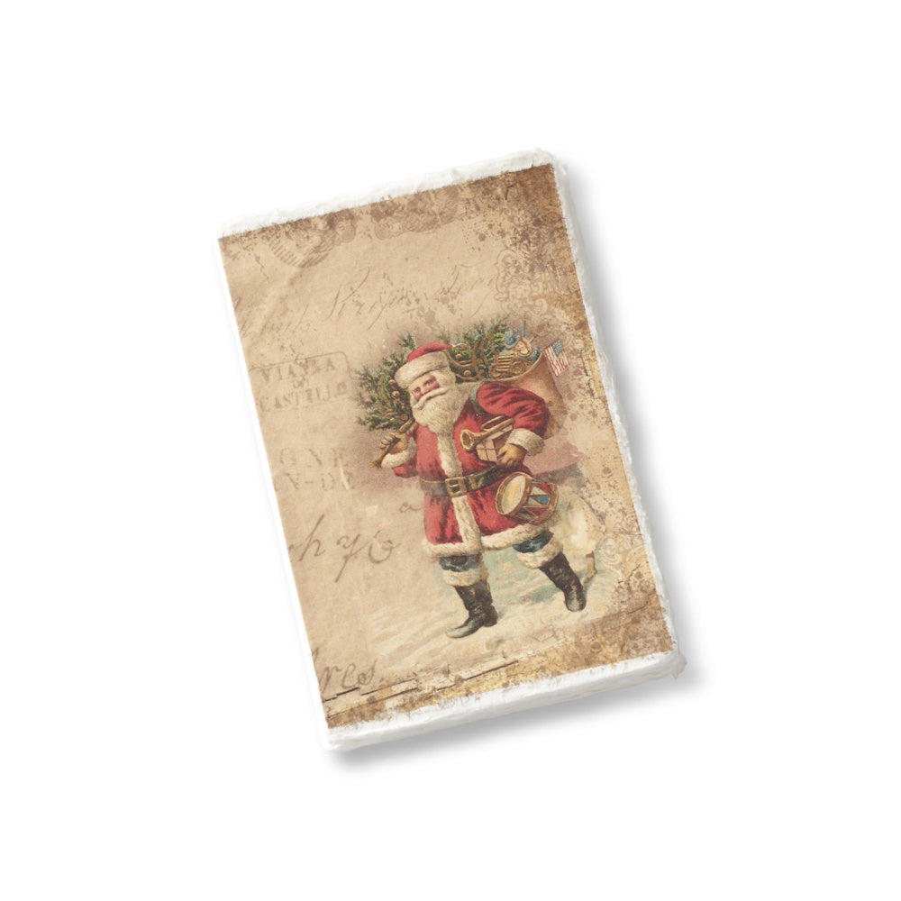 A soft-cover Christmas journal featuring a vintage illustration of Santa carrying a sack of presents and a deckle edge.