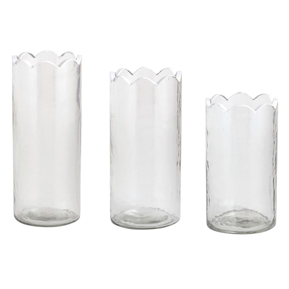 Set of three graduated clear glass cylinder bud vases with scalloped rims and a subtle hammered texture on white background.