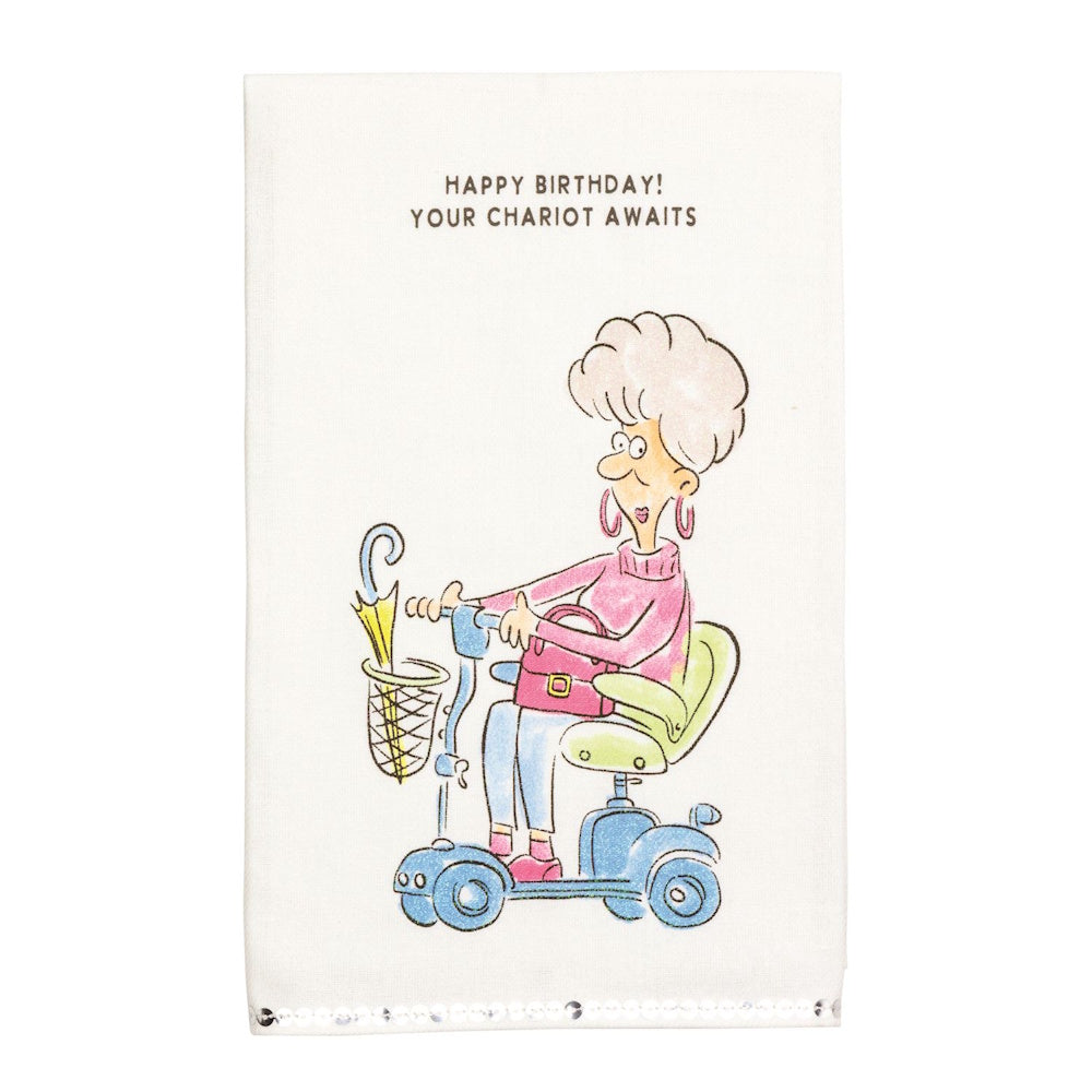 Towel with cartoon woman on a mobility scooter: 'HAPPY BIRTHDAY! YOUR CHARIOT AWAITS'.