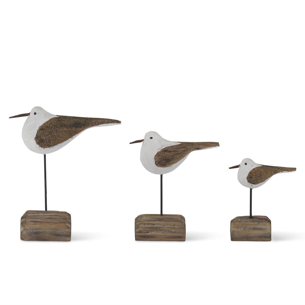 Set of three wooden seagull figurines on driftwood bases in varying sizes, rustic coastal home decor.