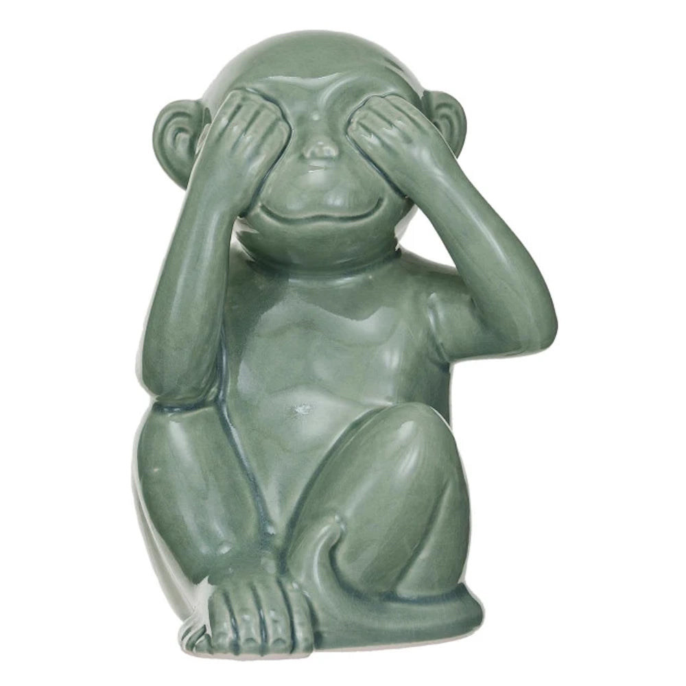 Sage green stoneware monkey figurine in a "see no evil" pose with hands over its eyes. Perfect for shelf or desk decor.