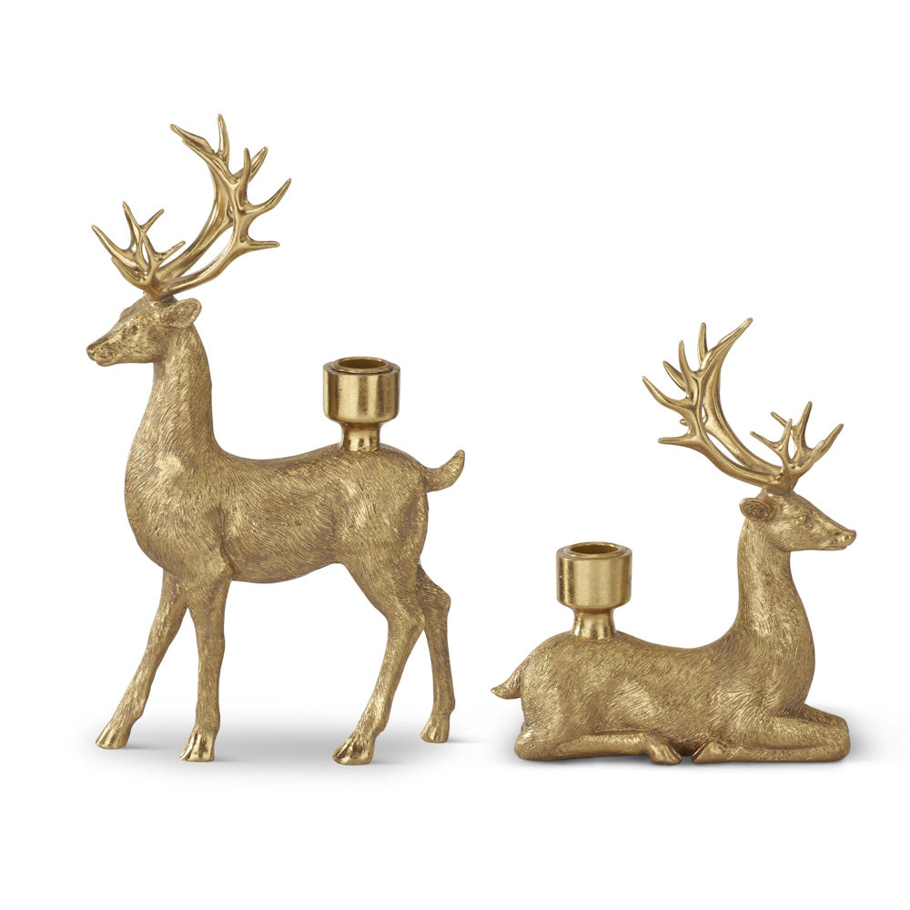 Set of two gold resin deer taper candleholders featuring one standing and one lying deer.