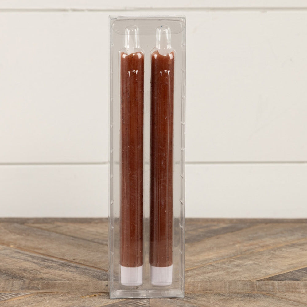 Two speckled bronze taper candles packaged in a clear plastic display box.