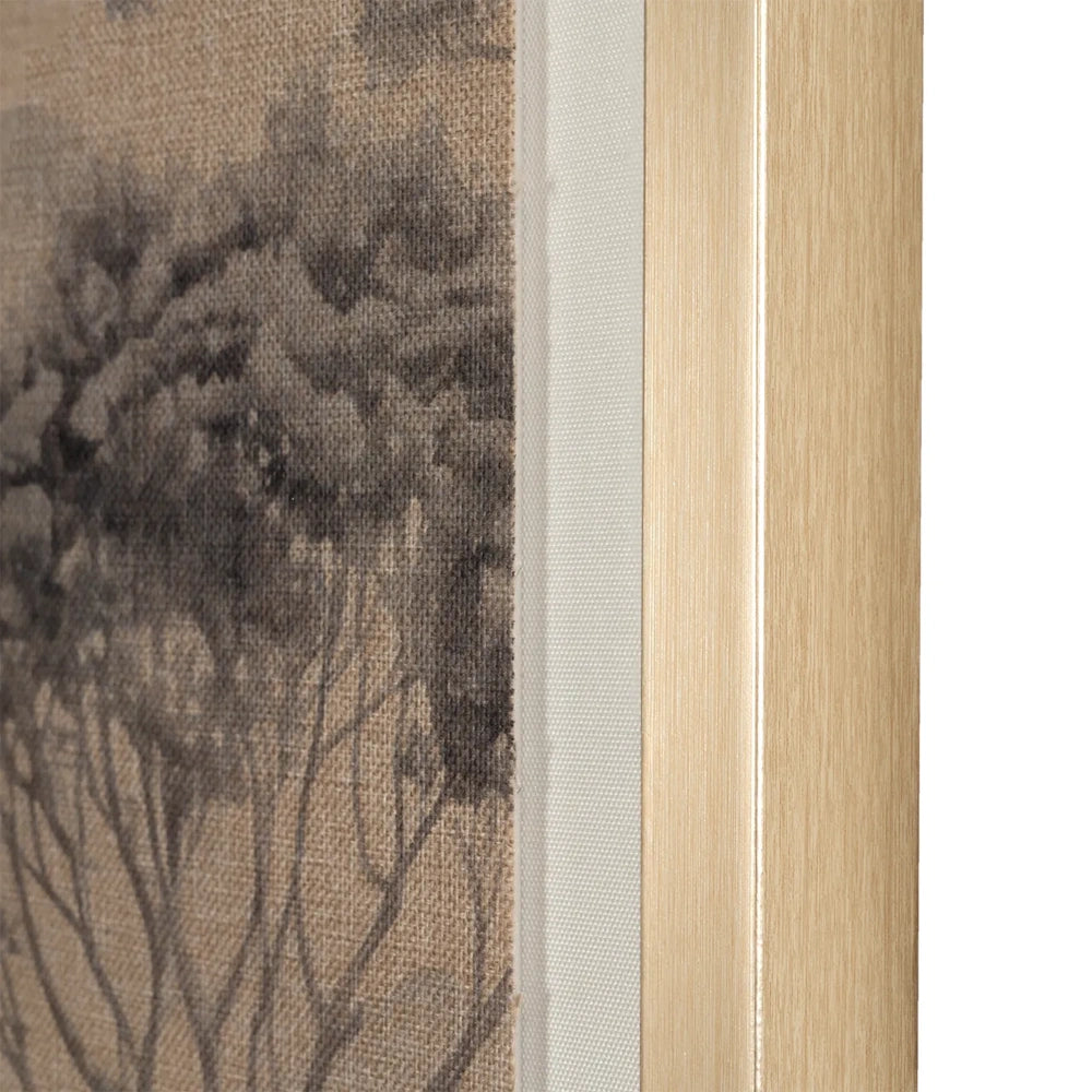 Close-up of a light gold wooden frame edge with textured canvas wall art showing monochrome tree details.
