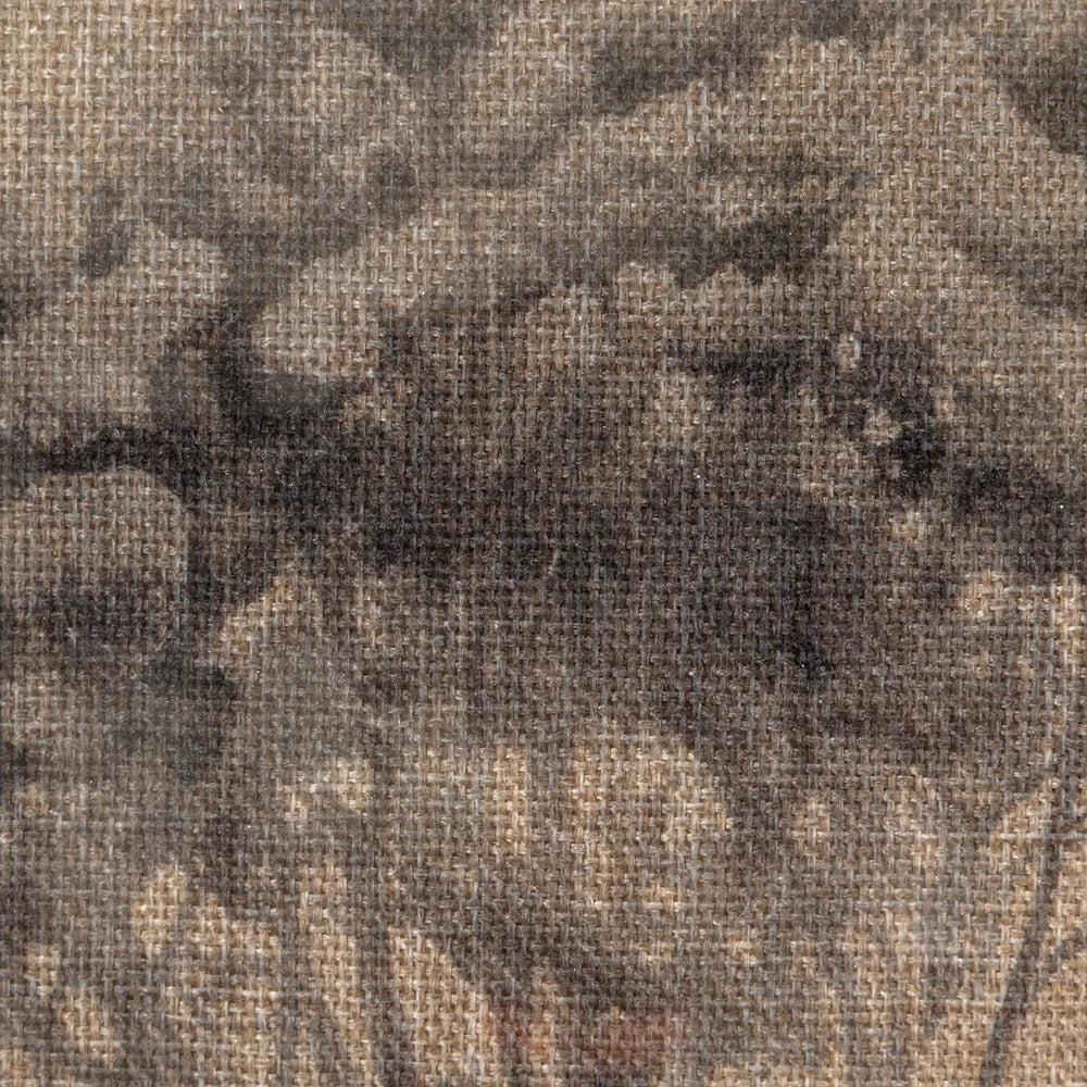 Close-up view of textured linen fabric with a dark, muted abstract botanical or landscape print.