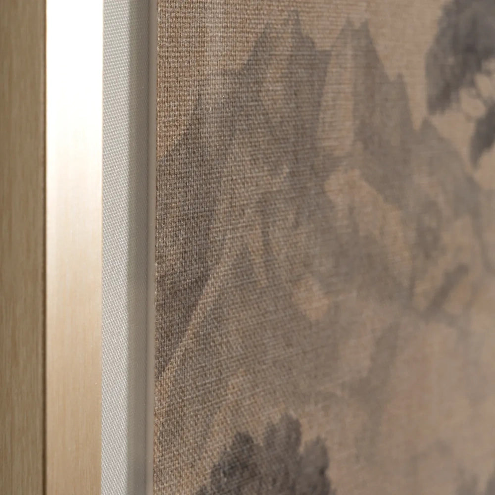 Close-up showing the textured linen canvas texture and light gold frame edge of a sepia wall art piece.