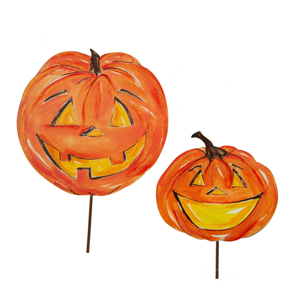 Set of two smiling orange jack o lantern Halloween yard stakes on a white background.