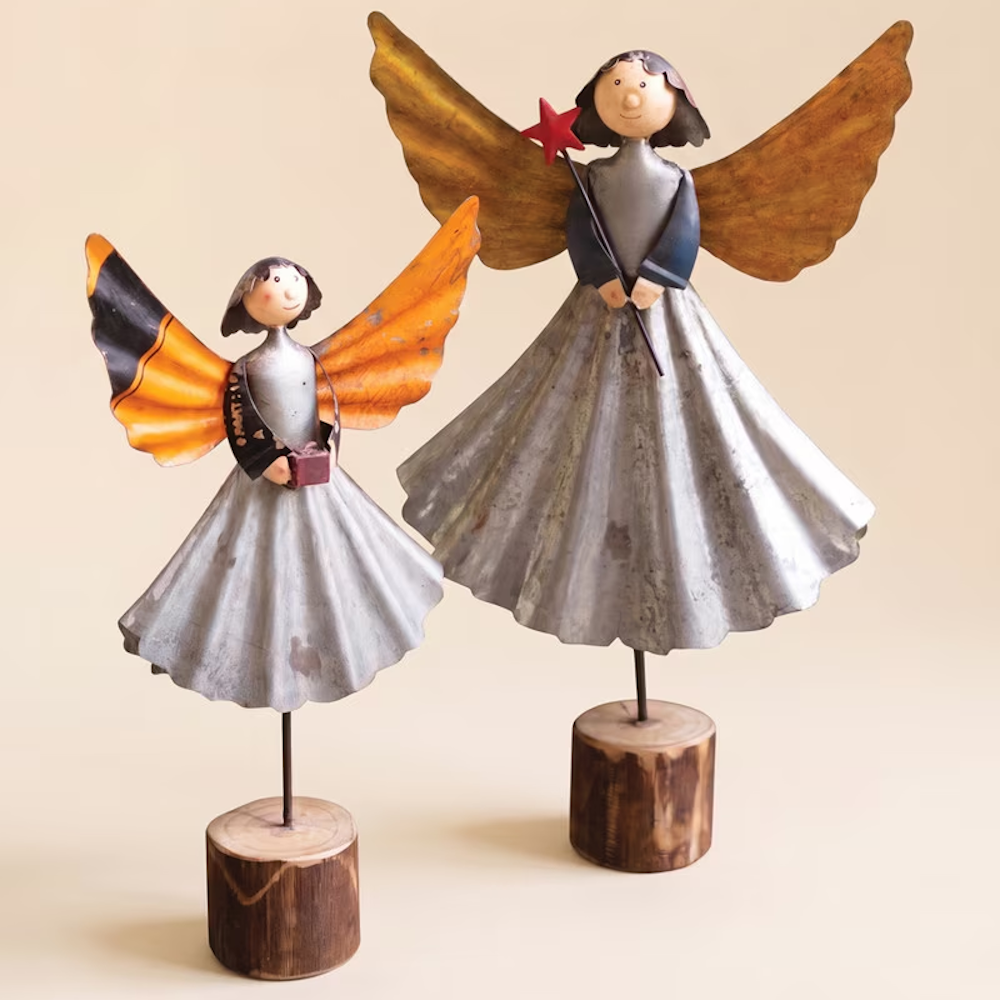 Set of two recycled metal angel figurines with wooden bases against a plain background.