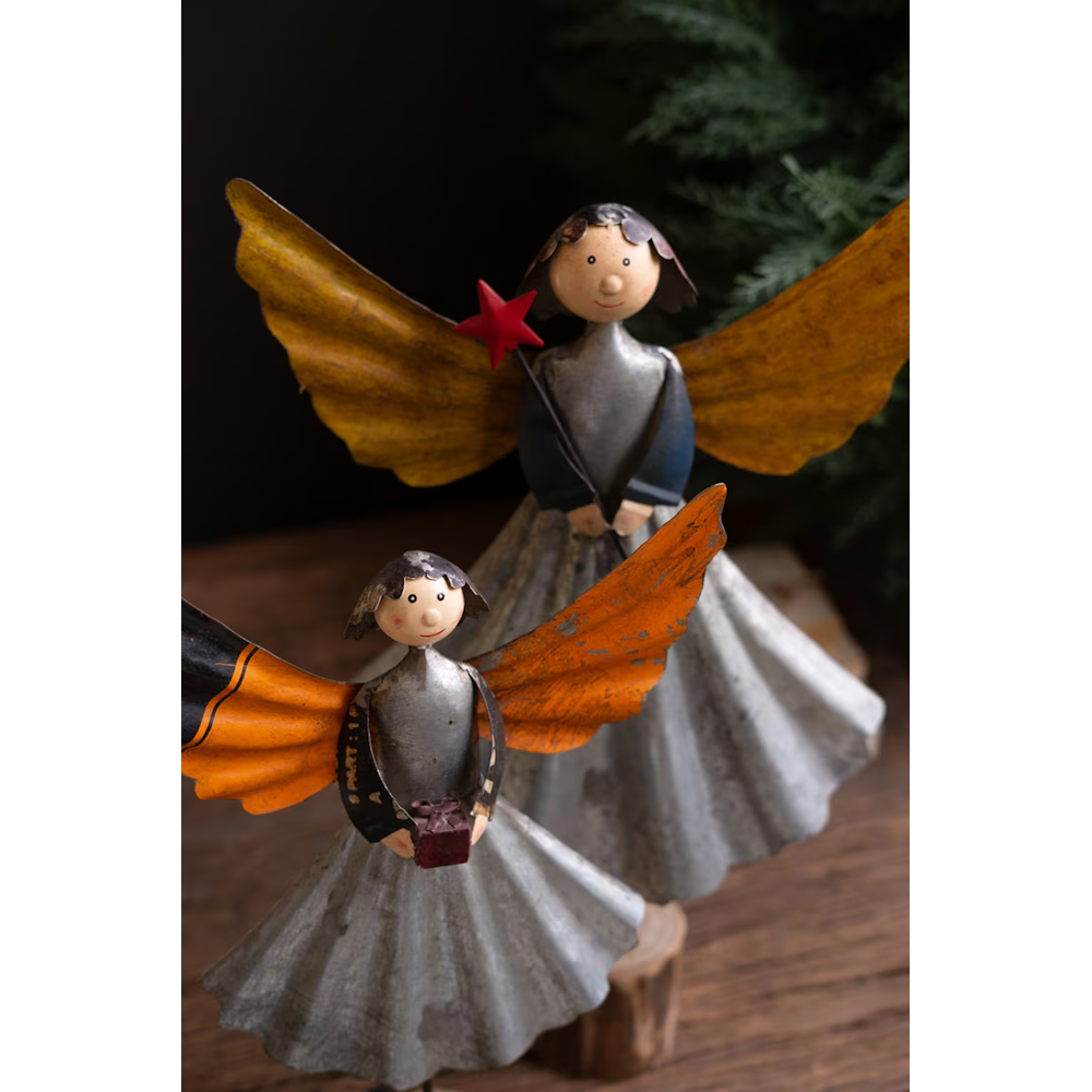 Close-up view of two handcrafted recycled metal angel statues featuring yellow and orange wings.