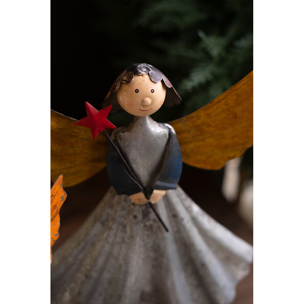 Detailed view of a handcrafted recycled metal angel figurine holding a red star wand.