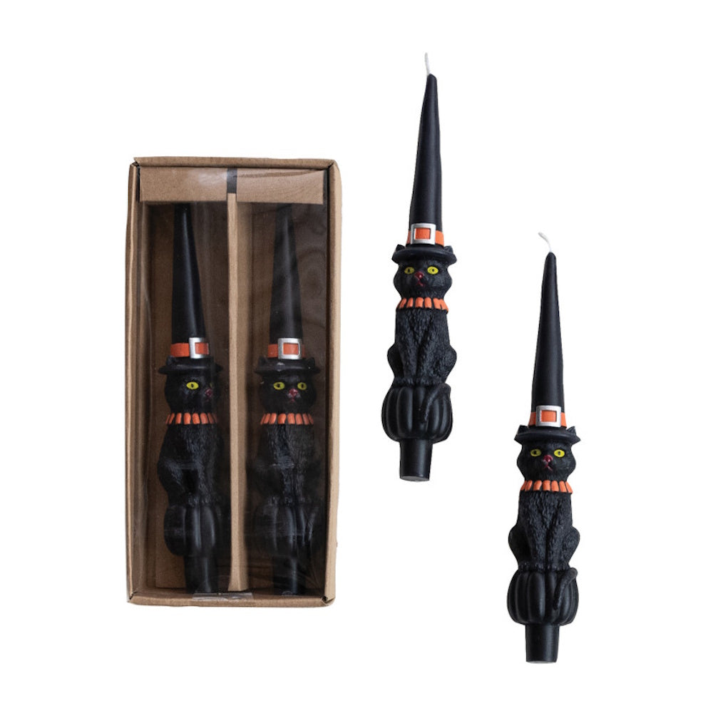 Set of black taper candles shaped like cats wearing pointy witch hats.