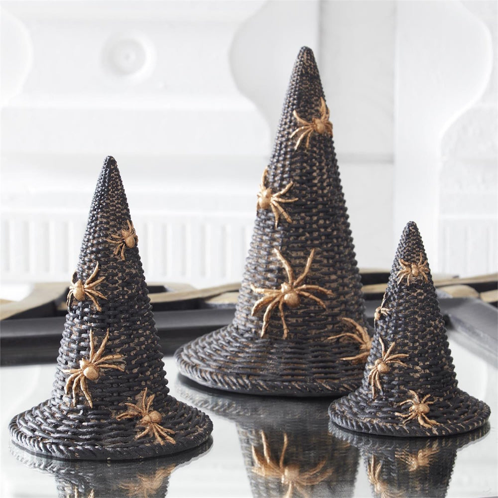 Three black woven witch hat decorations with gold spiders.