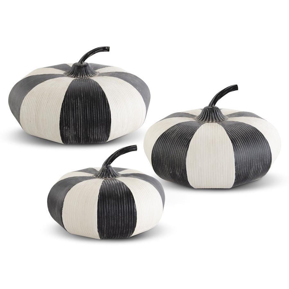 Set of three black and white striped metal decorative pumpkins of varying sizes with curved black stems.