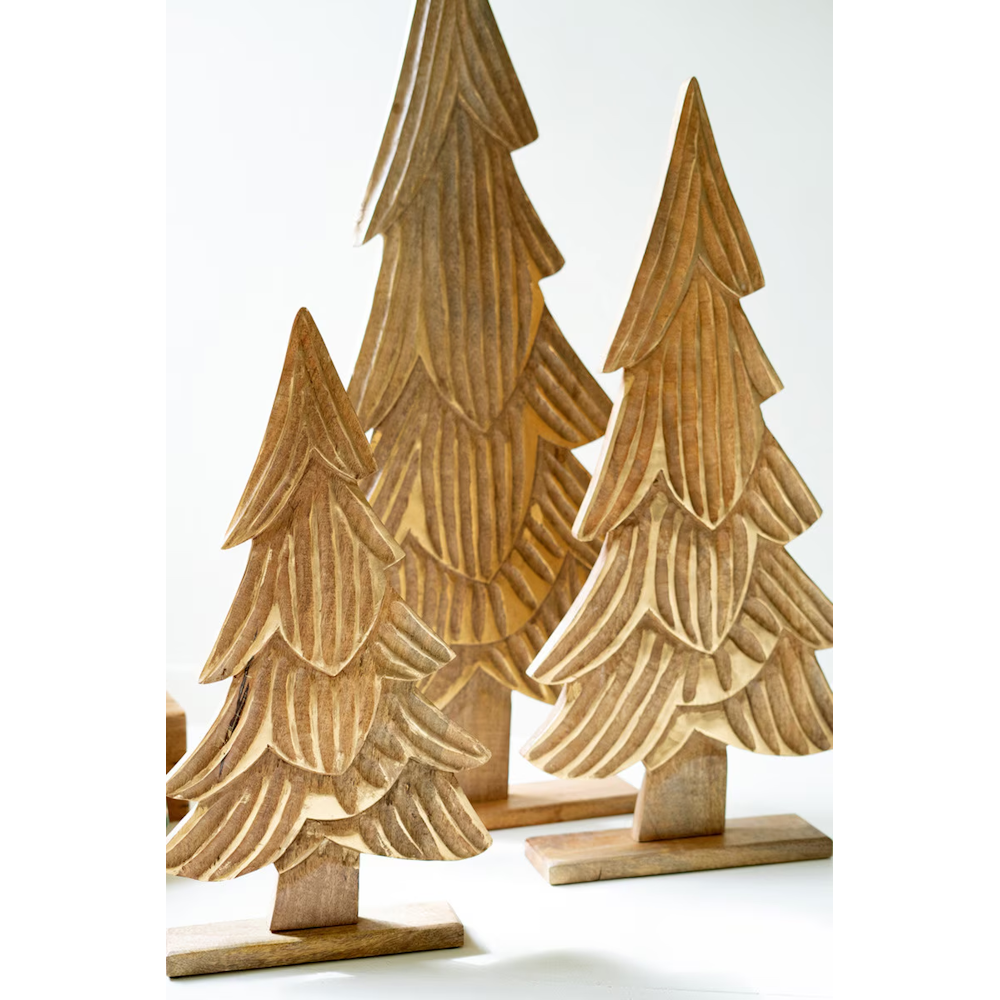 Trio of carved mango wood Christmas trees with gold-detailed branches on flat bases.