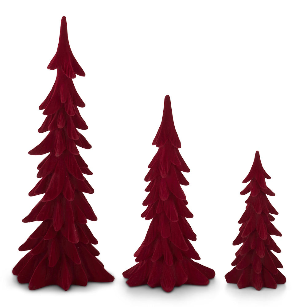 Set of three deep red velvet tabletop Christmas trees in varying sizes with layered, stylized branches.