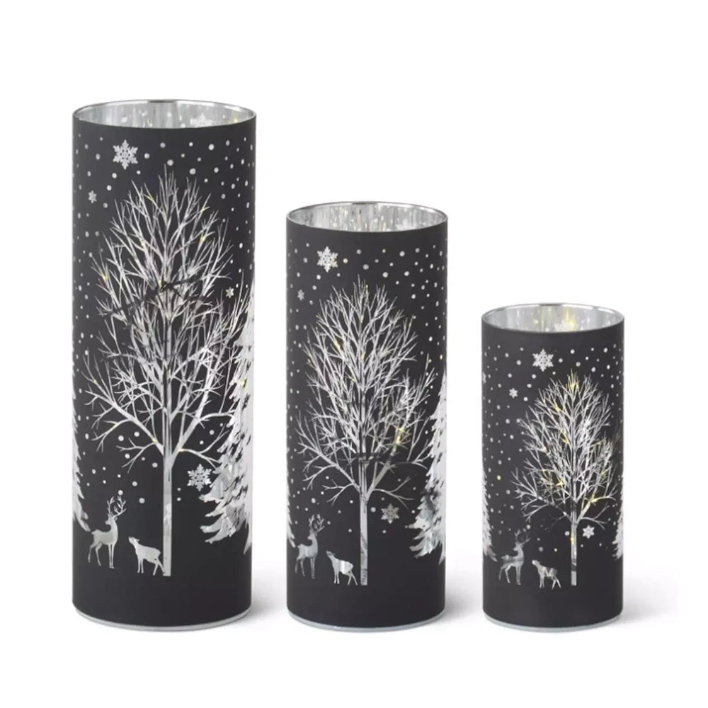 Set of 3 black LED glass cylinders featuring silver laser-engraved winter trees, deer, and snowflakes.