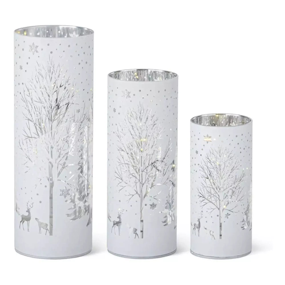 Set of 3 white LED glass cylinders featuring silver laser-engraved winter trees, deer, and snowflakes.