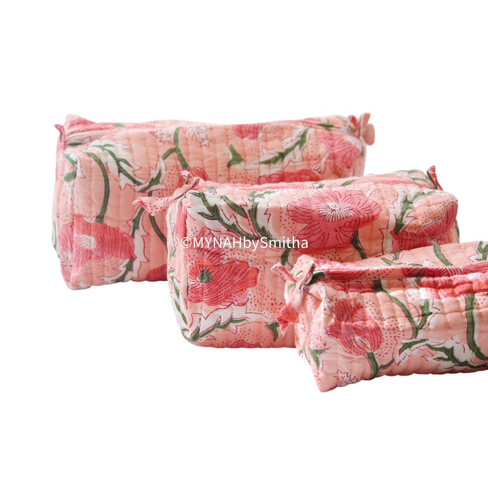 Set of 3 peach block print quilted cotton zipper pouches with a pink poppy floral pattern.