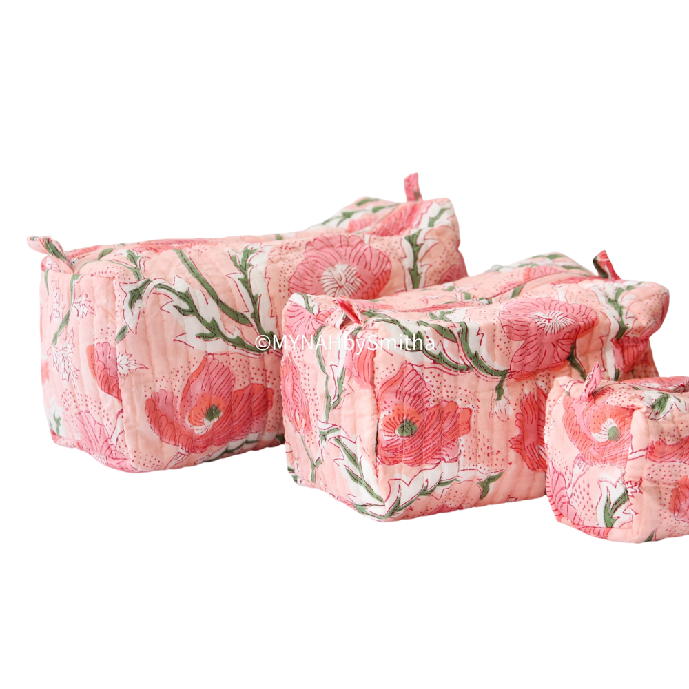Set of three peach quilted cosmetic zipper pouches in varying sizes with a vibrant floral poppy print.