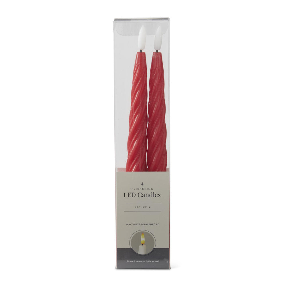 A set of two red spiral flickering LED taper candles in clear packaging.