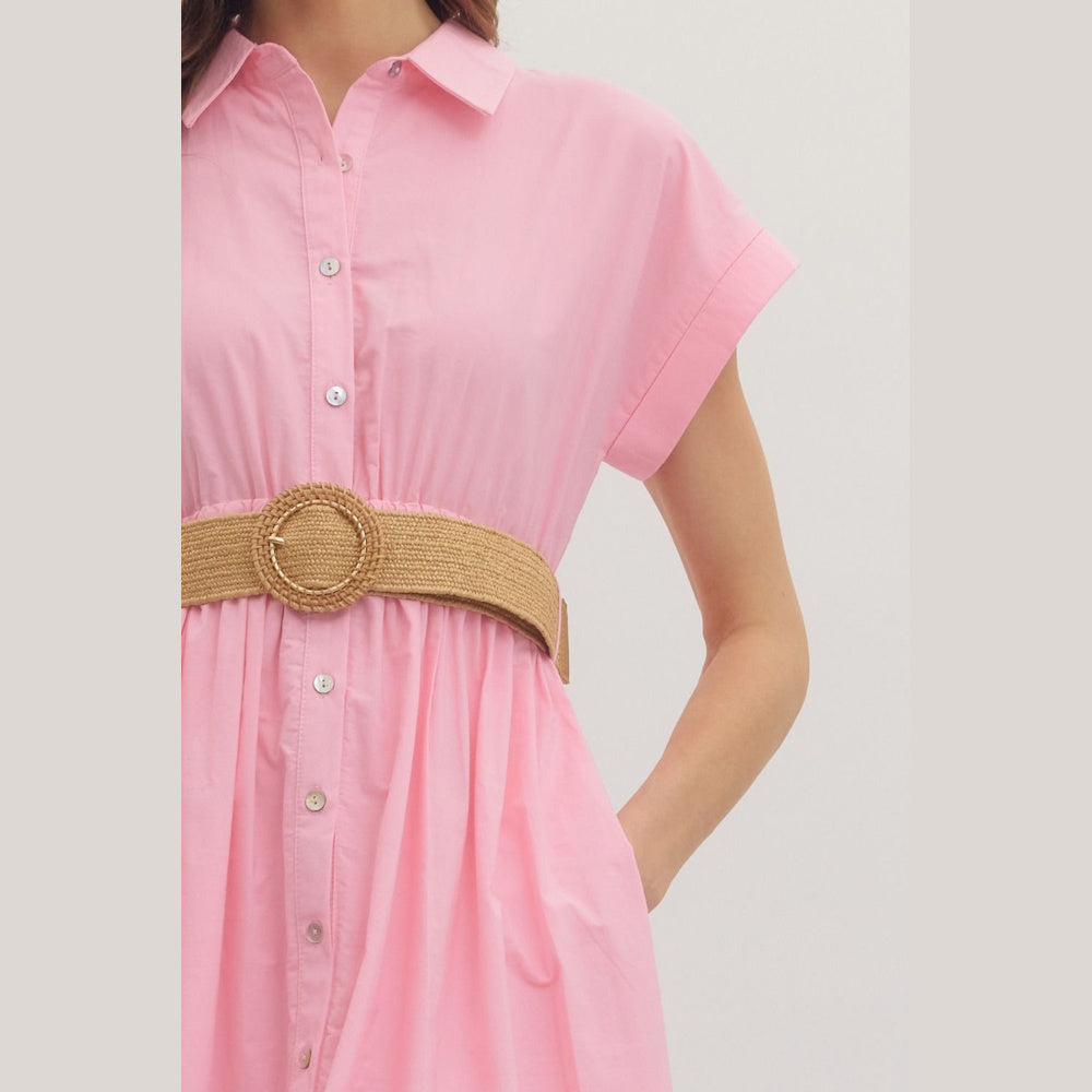 Close-up of a pink short-cuff sleeve midi shirt dress featuring a tan woven straw belt with a gold buckle.