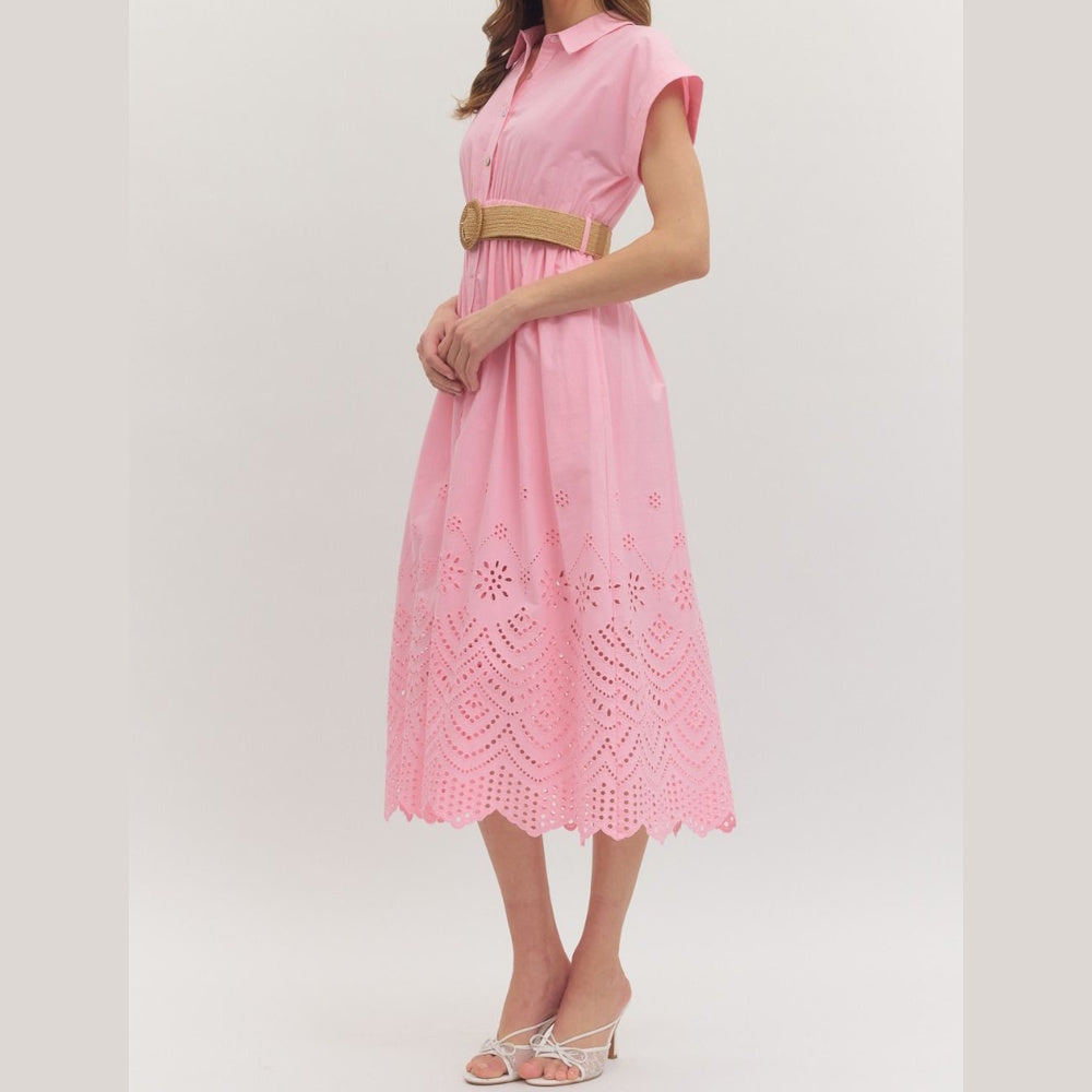 Pink midi dress with short cuffed sleeves, eyelet hem detail, and a woven belt. Side angle view on a model.