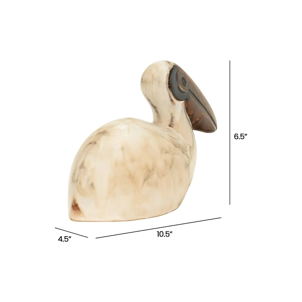 Beige pelican sculpture with dimensions of 6.5 inches high, 10.5 inches long, and 4.5 inches wide.