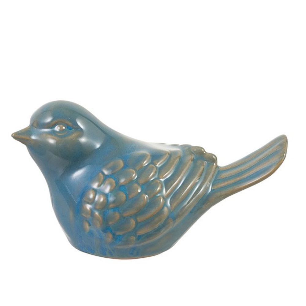 Side profile of a blue glazed ceramic bird figurine with textured feathers and brown accents on a white background.
