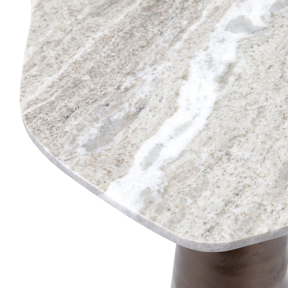 Close-up of a light beige and white marbled stone tabletop with natural veining on a dark base.