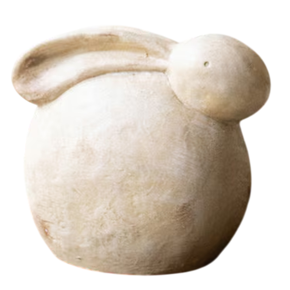 Rustic cream-colored faux stone rabbit sculpture in a rounded, minimal design on a white background.
