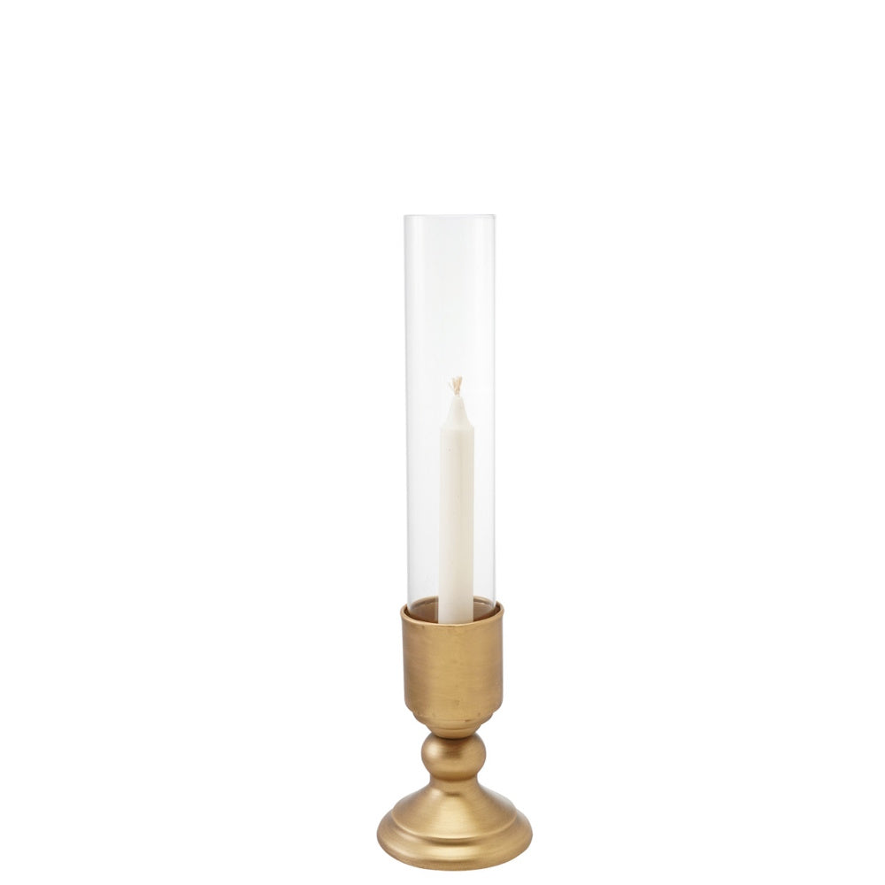 Gold metal taper candle holder topped with a clear glass hurricane shield holding a white candle.