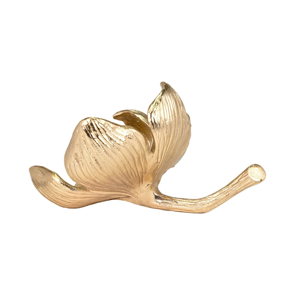 Gold flower sculpture with textured petals and a short curved stem on a white background.