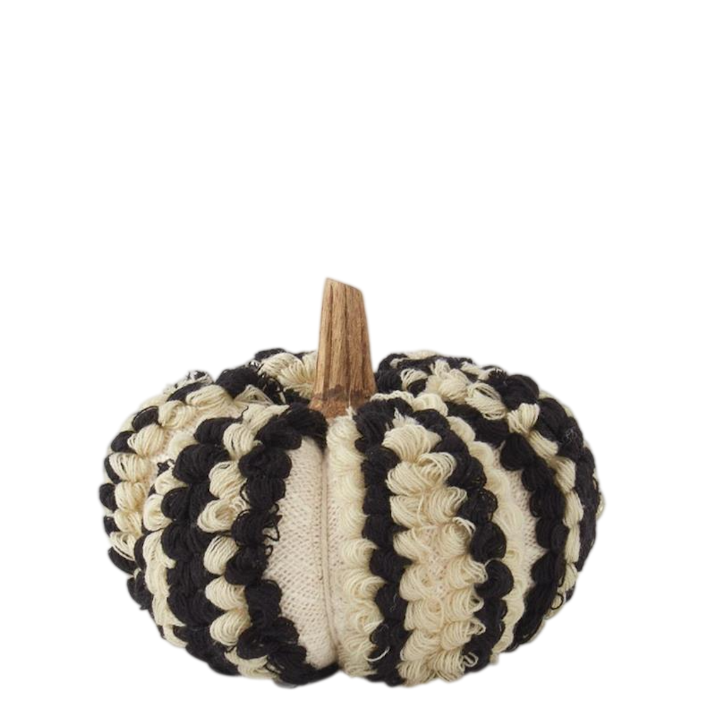 A small fabric pumpkin with black and cream textured yarn stripes and a wooden stem on a white background.