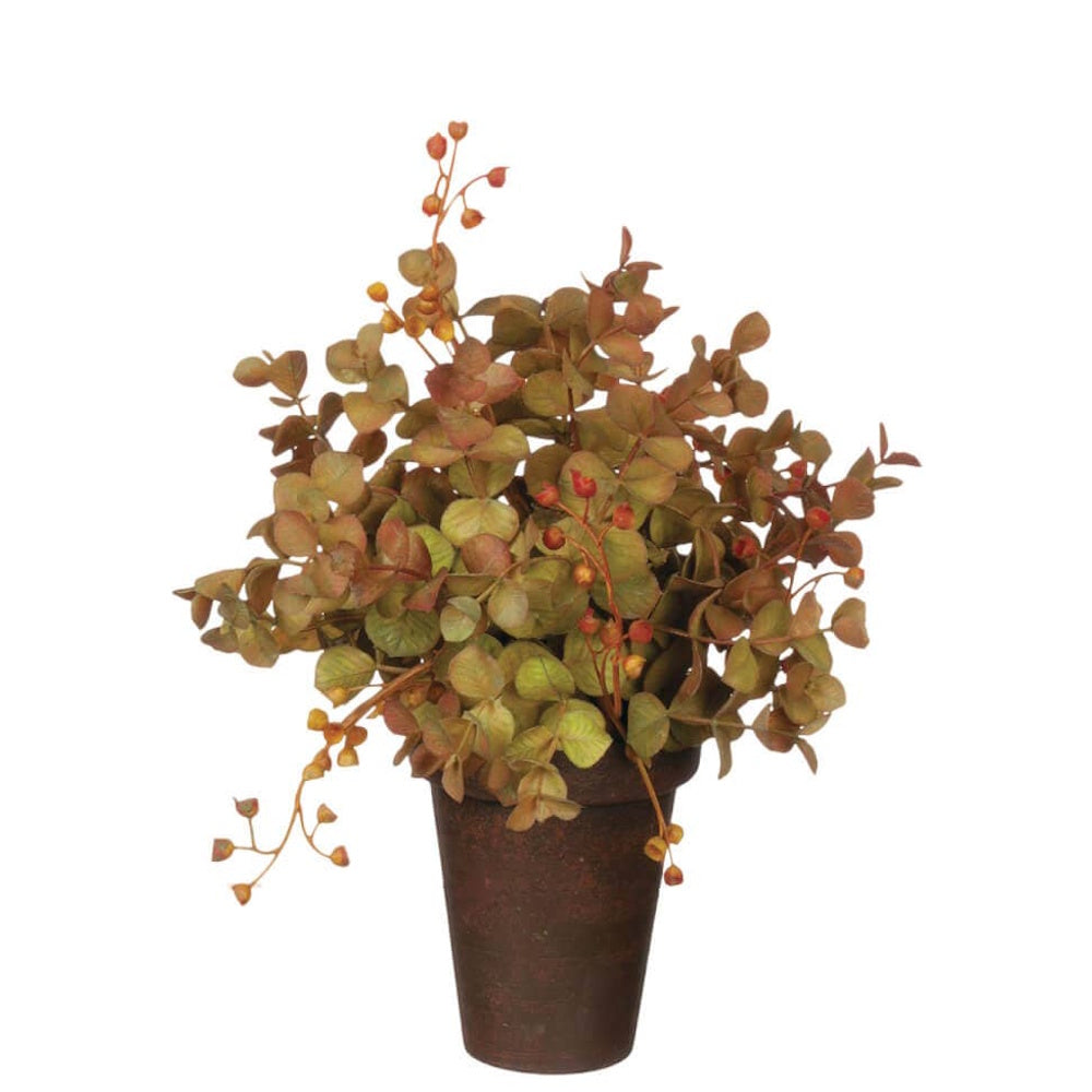 An artificial potted eucalyptus plant with autumn-toned green and rust leaves in a dark brown pot.