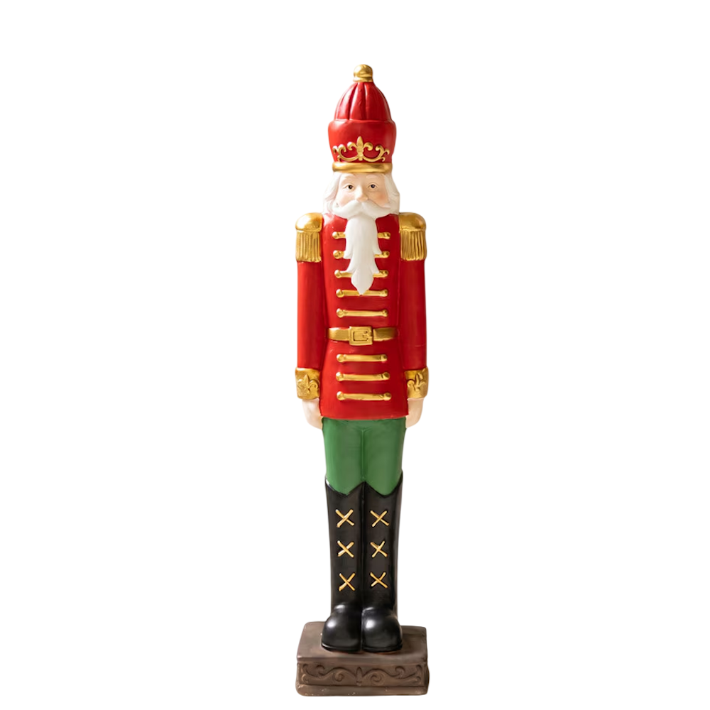 Small faux concrete Christmas nutcracker soldier statue wearing a red jacket and tall cap.