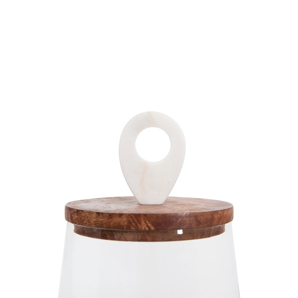 Close-up of a wooden jar lid topped with a white marble ring-shaped handle, on a white background.