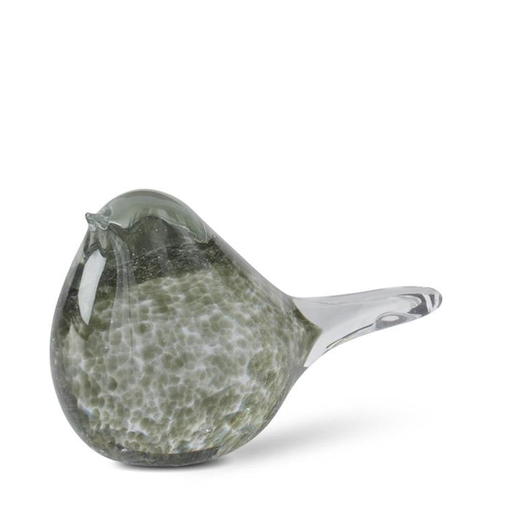 Small, clear glass bird figurine with green speckled patterns inside, featuring a smooth, rounded body and pointed tail.
