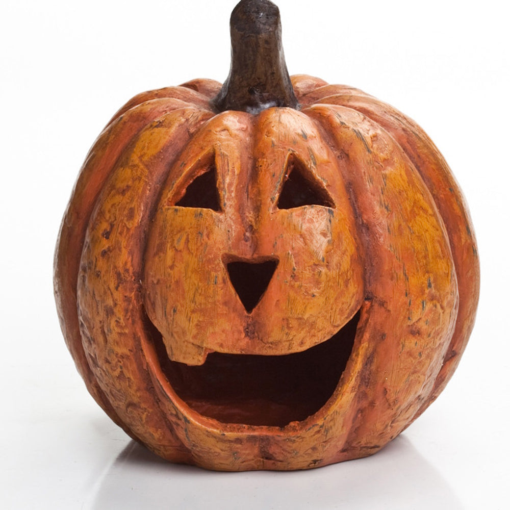Rustic orange jack-o'-lantern carving with a wide open-mouthed grin against a plain white background.