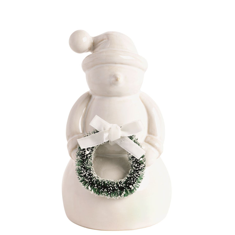 White ceramic snowman figurine holding a miniature green wreath with a white bow.