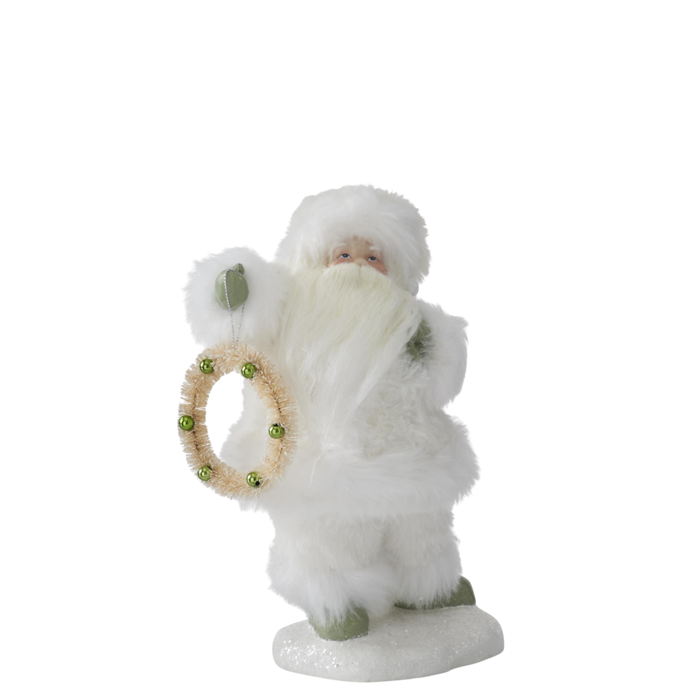 Small Santa figurine wearing a white faux fur suit and holding a wreath with green ornaments.