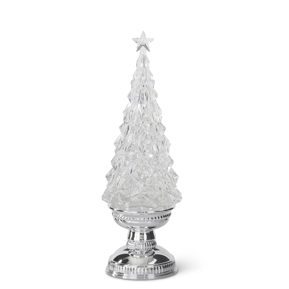 Clear acrylic Christmas tree figurine with a star topper, resting on an ornate silver pedestal base.