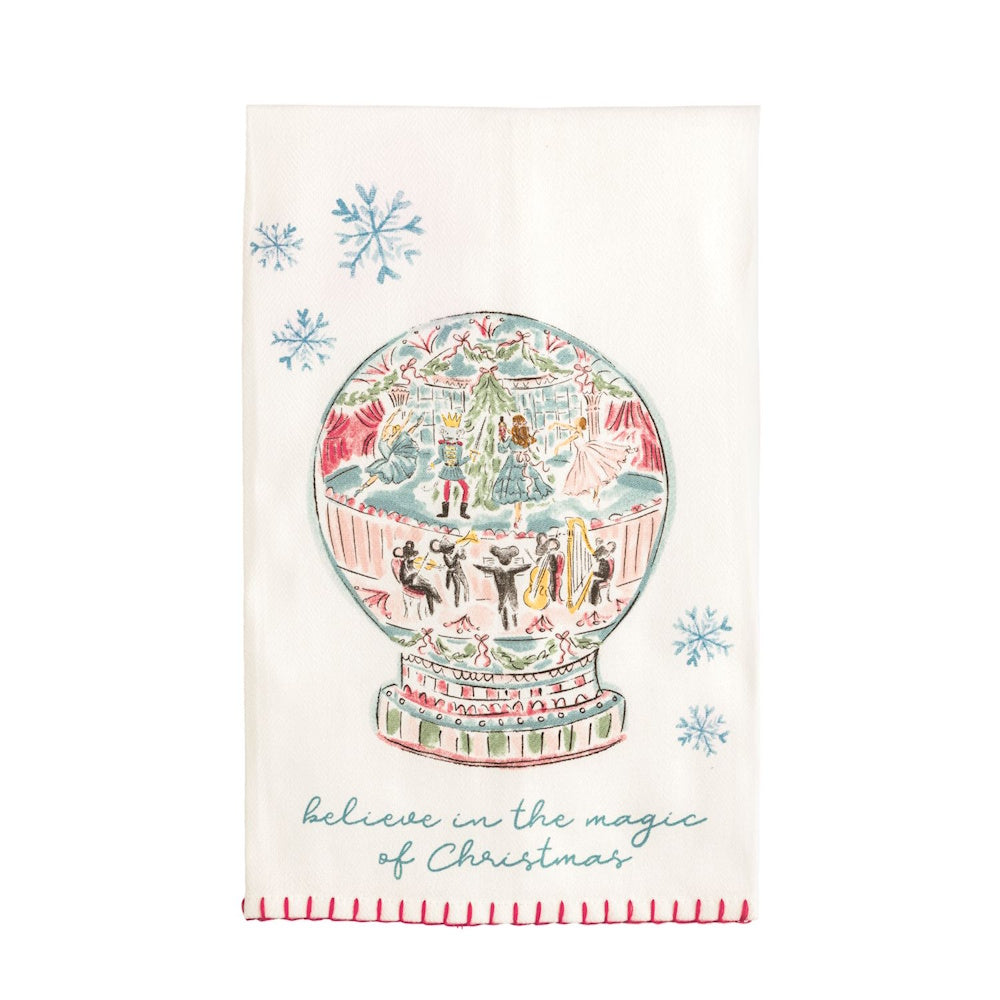 Holiday kitchen towel featuring a snow globe with a Nutcracker scene and "believe in the magic" text.